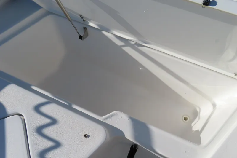 Slide: The Image of Open storage compartment on 2018 Sea Hunt Ultra 234 boat. - 11