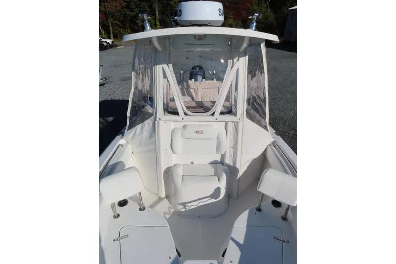 Slide: The Image of 2018 Sea Hunt Ultra 234 boat with enclosed helm and seating area. - 12