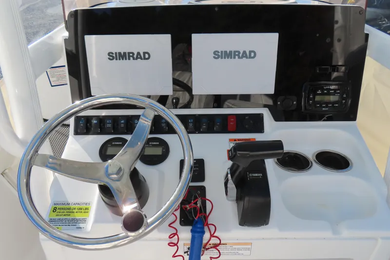 Slide: The Image of 2018 Sea Hunt Ultra 234 boat dashboard with Simrad displays and Yamaha controls. - 19