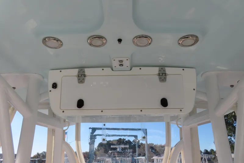 Slide: The Image of 2018 Sea Hunt Ultra 234 boat interior with overhead storage and lighting. - 22