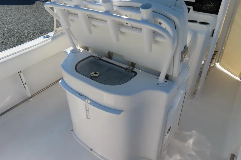 Slide: The Image of 2018 Sea Hunt Ultra 234 boat interior with storage compartment and rod holders. - 24
