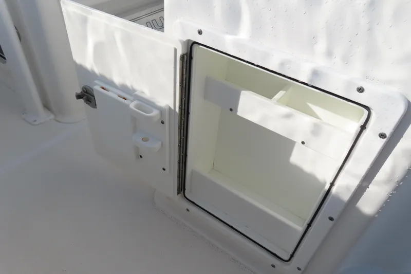 Slide: The Image of Open storage compartment on 2018 Sea Hunt Ultra 234 boat. - 26