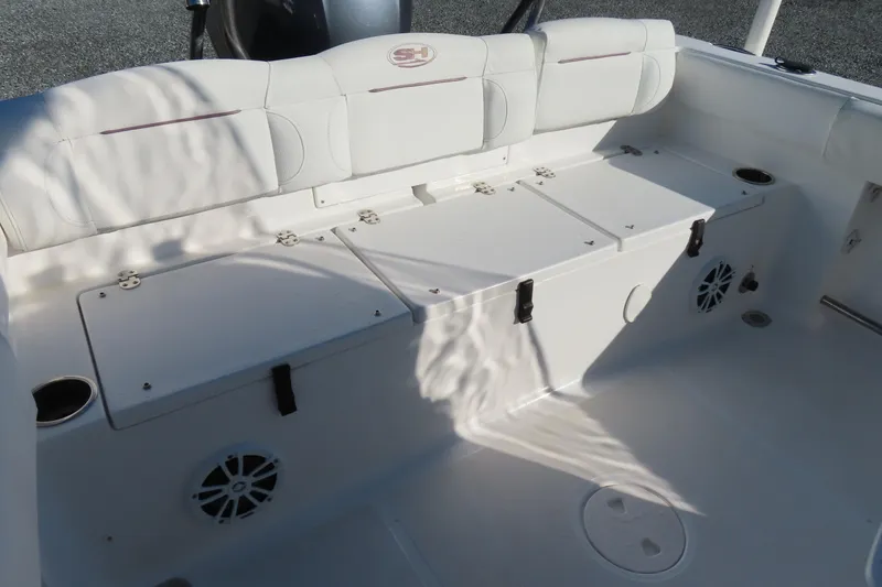 Slide: The Image of 2018 Sea Hunt Ultra 234 boat interior with white seating and storage compartments. - 29