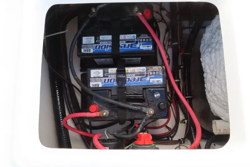 Slide: The Image of 2018 Sea Hunt Ultra 234 boat battery compartment with wiring and connections. - 30