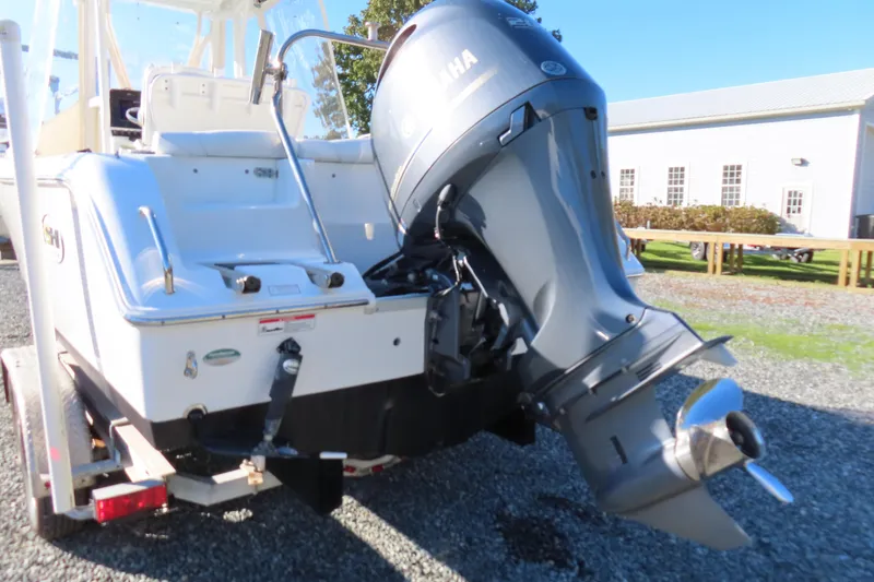 Slide: The Image of 2018 Sea Hunt Ultra 234 boat with Yamaha outboard motor, parked on a trailer. - 4