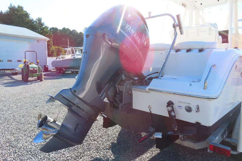 Slide: The Image of 2018 Sea Hunt Ultra 234 with Yamaha outboard motor in a sunny outdoor setting. - 5