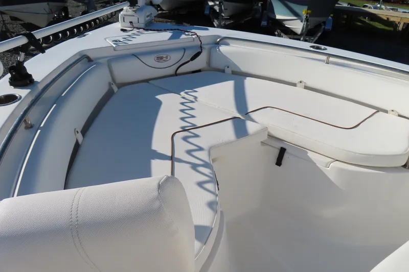 Slide: The Image of 2018 Sea Hunt Ultra 234 boat interior with cushioned seating and storage compartments. - 8