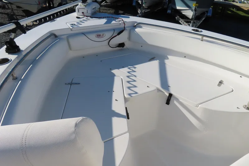 Slide: The Image of 2018 Sea Hunt Ultra 234 boat interior with seating and storage compartments. - 9