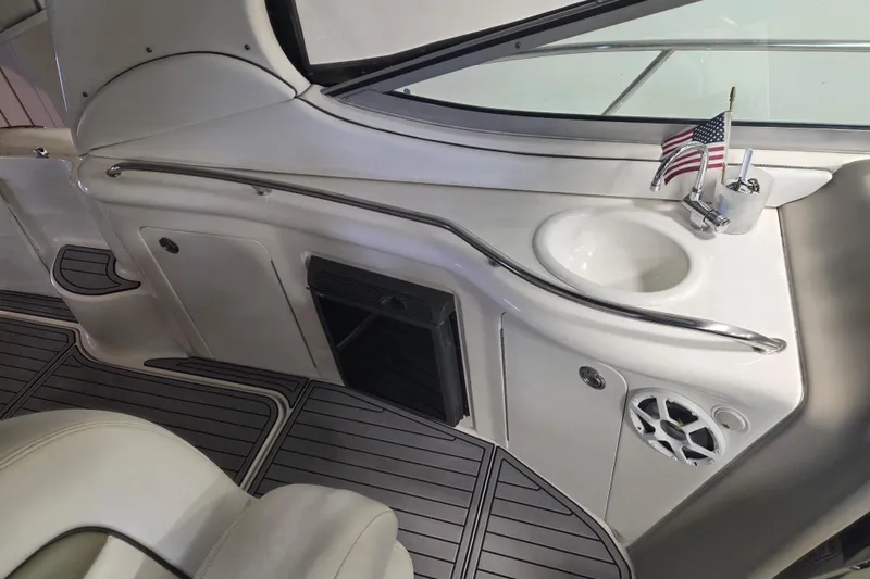 Slide: The Image of Interior of 2006 Sea Ray 300 Sundancer with sink, American flag, and speaker. - 13
