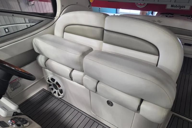 Slide: The Image of 2006 Sea Ray 300 Sundancer interior with white leather seating and speaker detail. - 15
