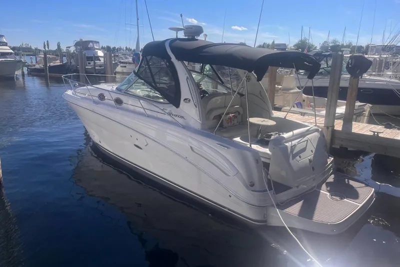 Slide: The Image of 2006 Sea Ray 300 Sundancer docked at marina under clear blue sky. - 2