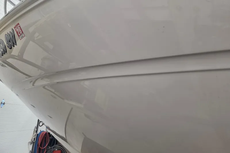 Slide: The Image of 2006 Sea Ray 300 Sundancer boat hull in a storage facility. - 24