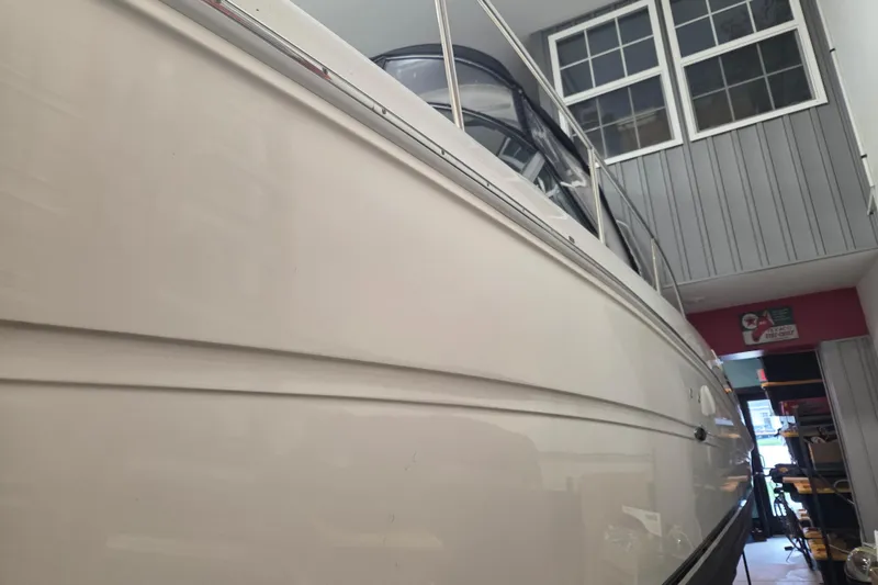 Slide: The Image of 2006 Sea Ray 300 Sundancer boat in indoor storage, side view. - 25