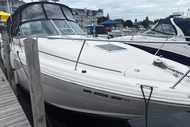 Slide: The Image of 2006 Sea Ray 300 Sundancer docked at marina, featuring sleek white design. - 3