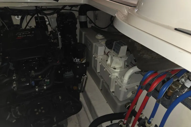 Slide: The Image of Engine compartment of a 2006 Sea Ray 300 Sundancer boat, showcasing mechanical components. - 30