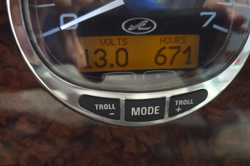 Slide: The Image of Close-up of Sea Ray 300 Sundancer 2006 dashboard showing 13 volts and 671 hours. - 31