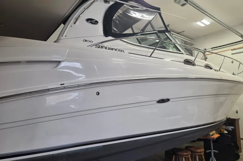 Slide: The Image of 2006 Sea Ray 300 Sundancer boat in a garage, side view. - 5