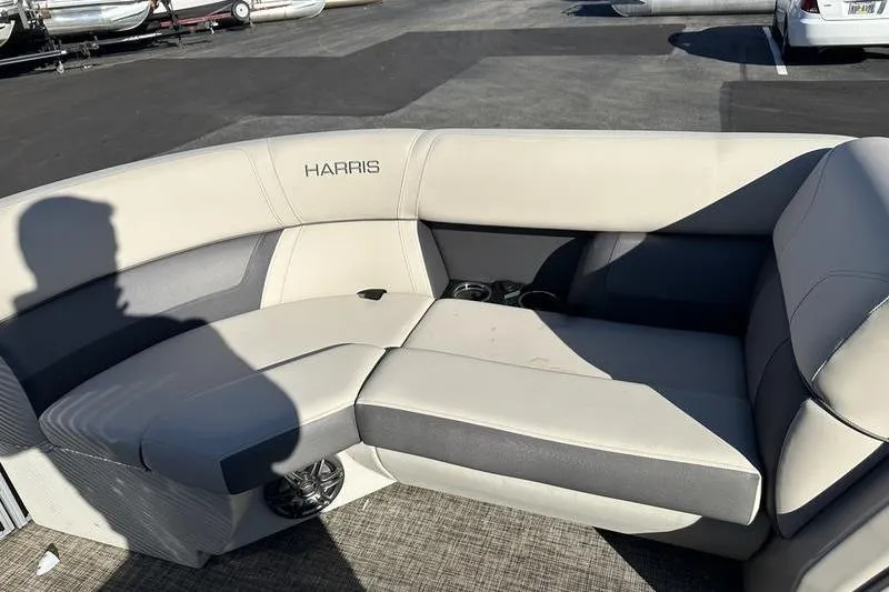 Slide: The Image of 2023 Harris Cruiser 210 CS boat interior with beige seating and cup holders. - 12