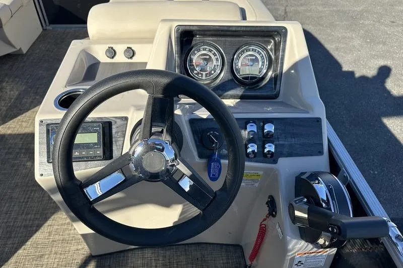 Slide: The Image of Steering console of 2023 Harris Cruiser 210 CS boat with gauges and controls. - 13