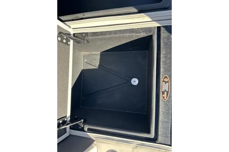 Slide: The Image of Storage compartment of 2023 Harris Cruiser 210 CS boat, featuring a black interior. - 19