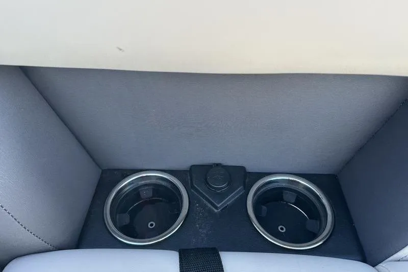 Slide: The Image of 2023 Harris Cruiser 210 CS boat cup holders and power outlet. - 6