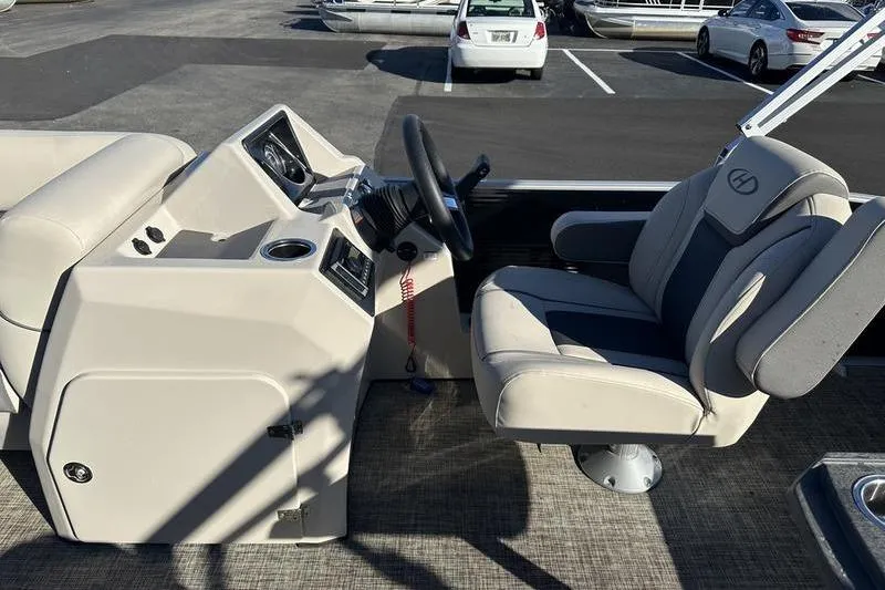 Slide: The Image of 2023 Harris Cruiser 210 CS boat interior with steering wheel and captain's chair. - 8