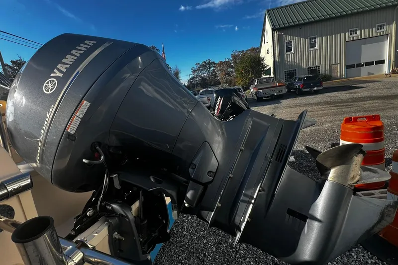 Slide: The Image of 2013 Grady-White Freedom 205 with Yamaha outboard motor in a parking lot. - 12