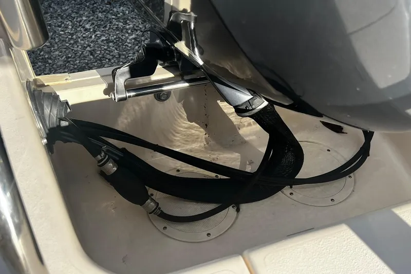 Slide: The Image of 2013 Grady-White Freedom 205 boat engine compartment with cables and fittings. - 16