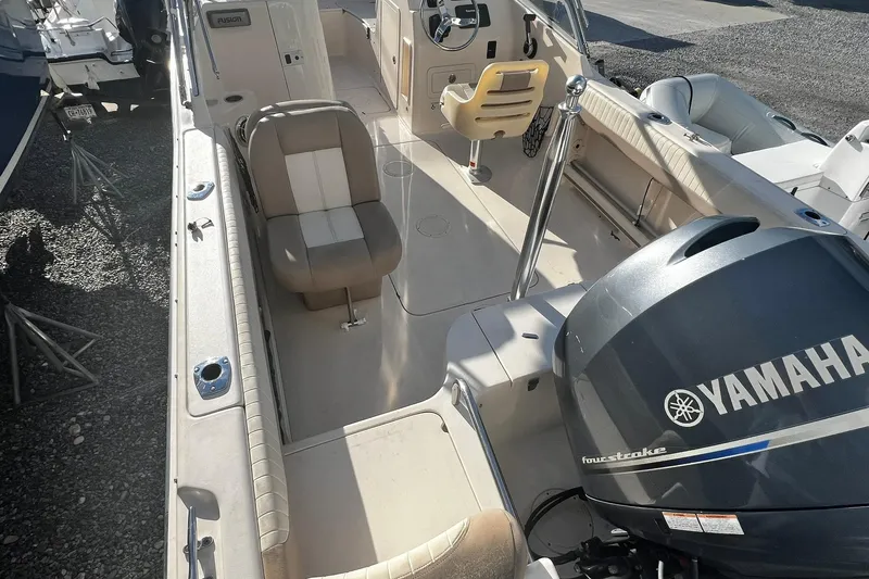 Slide: The Image of 2013 Grady-White Freedom 205 boat interior with Yamaha engine, beige seating, and steering console. - 17