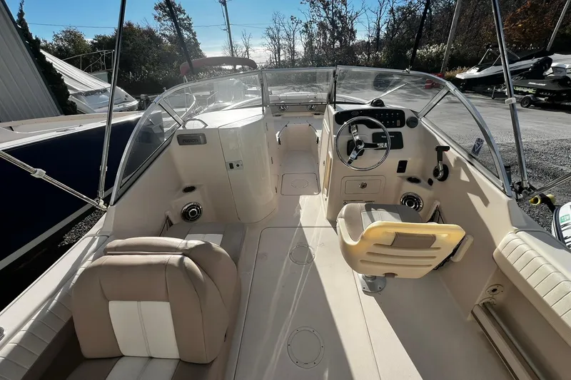 Slide: The Image of 2013 Grady-White Freedom 205 boat interior with steering wheel and seating. - 18