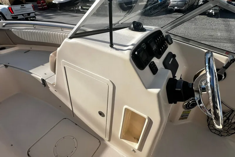 Slide: The Image of 2013 Grady-White Freedom 205 boat interior with steering wheel and dashboard controls. - 24