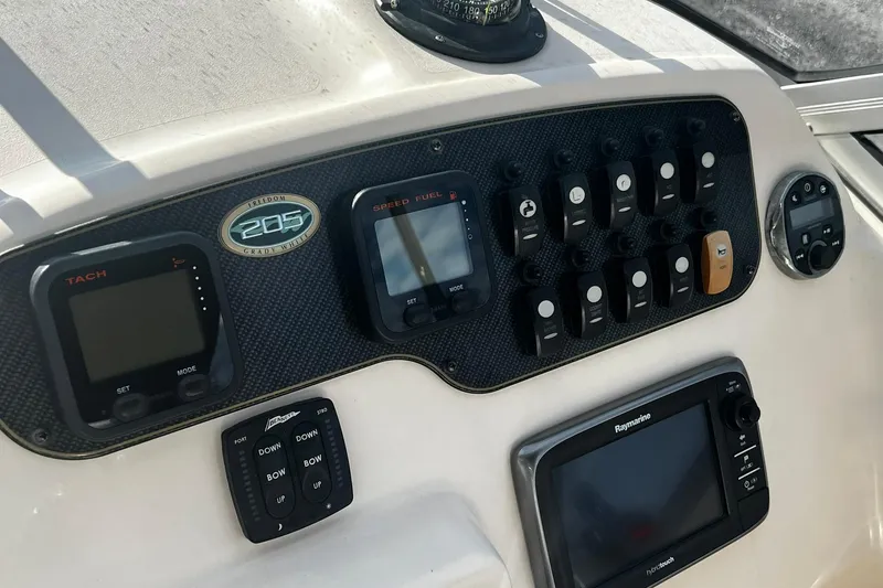 Slide: The Image of Control panel of 2013 Grady-White Freedom 205 boat with gauges and switches. - 25