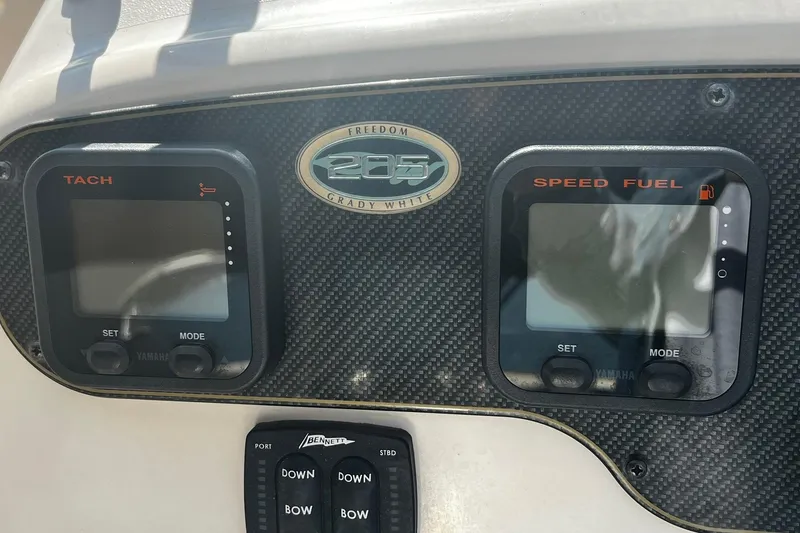 Slide: The Image of Dashboard of 2013 Grady-White Freedom 205 boat with tachometer and speed fuel gauges. - 30
