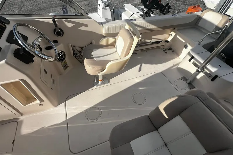 Slide: The Image of 2013 Grady-White Freedom 205 boat interior with steering wheel and seating area. - 34