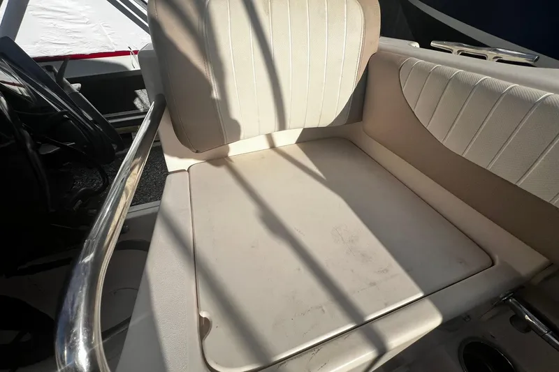 Slide: The Image of 2013 Grady-White Freedom 205 boat interior with cushioned seating and steering wheel. - 40