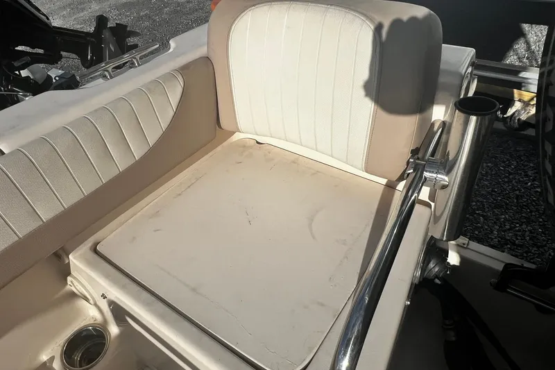 Slide: The Image of 2013 Grady-White Freedom 205 boat seat with beige upholstery and stainless steel railing. - 42