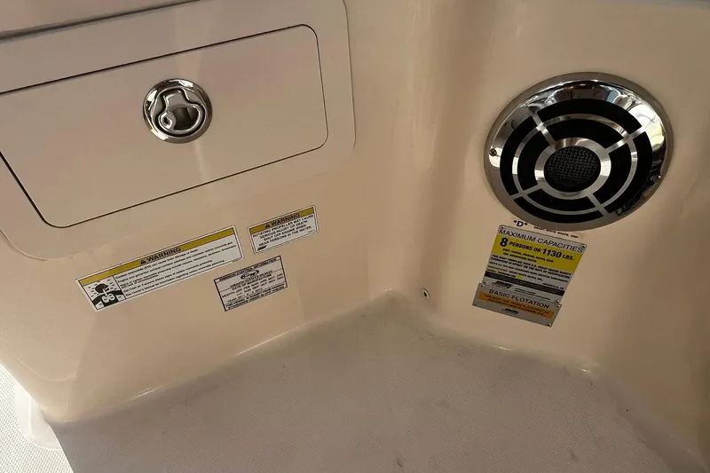 Slide: The Image of 2013 Grady-White Freedom 205 boat interior with speaker and capacity warning labels. - 44
