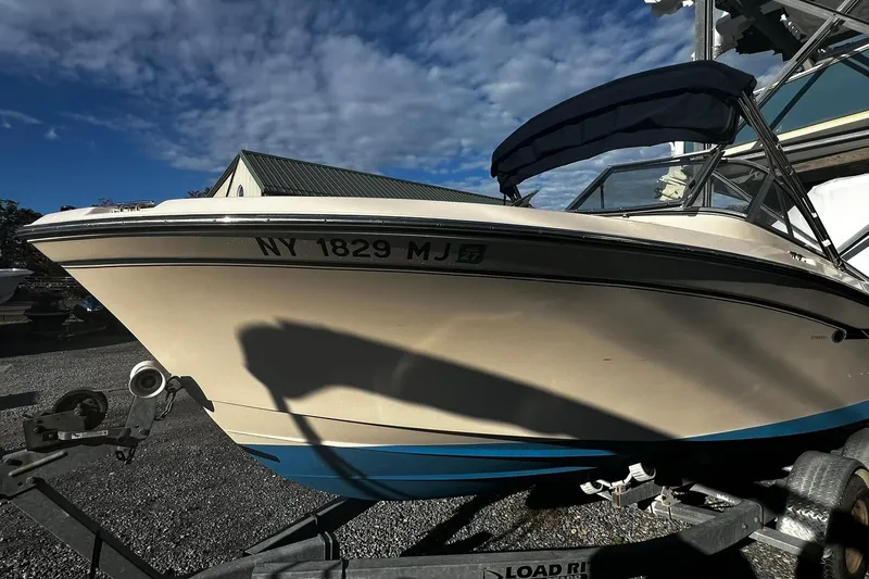 Slide: The Image of 2013 Grady-White Freedom 205 boat on trailer under blue sky. - 8