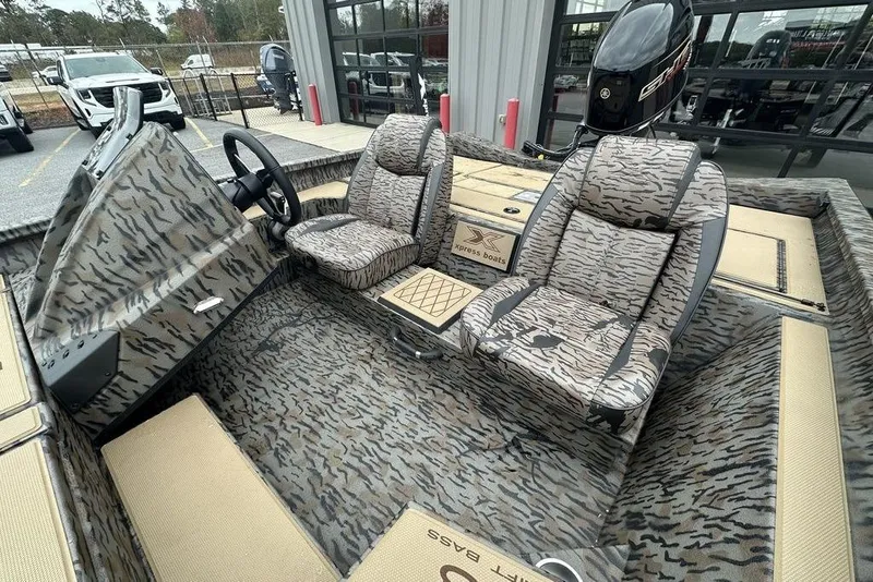 Slide: The Image of 2026 SeaArk ProCat 240 boat interior with camouflage seating and steering wheel. - 11