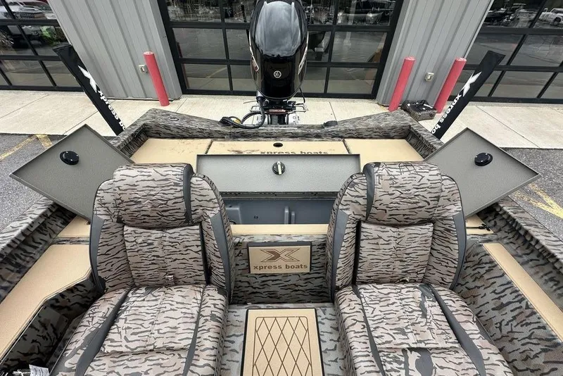 Slide: The Image of 2026 SeaArk ProCat 240 boat interior with camouflage seating and storage compartments. - 12