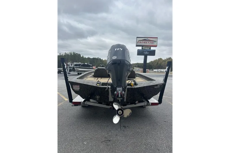 Slide: The Image of 2026 SeaArk ProCat 240 boat with outboard motor in parking lot. - 6