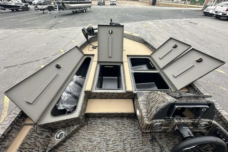 Slide: The Image of 2026 SeaArk ProCat 240 boat with open storage compartments and camouflage design. - 7