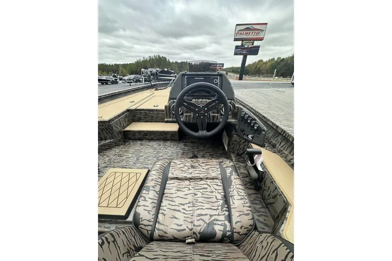 Slide: The Image of 2026 SeaArk ProCat 240 boat interior with camouflage design and steering console. - 8