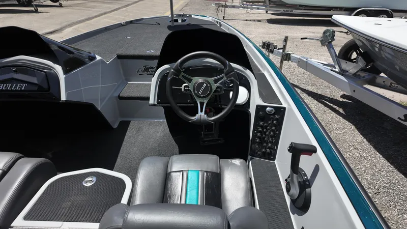 Slide: The Image of 2025 Bullet 21SDC boat interior with steering wheel and control panel. - 12