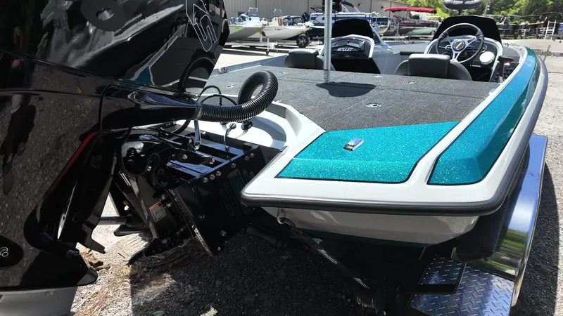 Slide: The Image of 2025 Bullet 21SDC boat with teal accents and sleek design in a marina setting. - 13