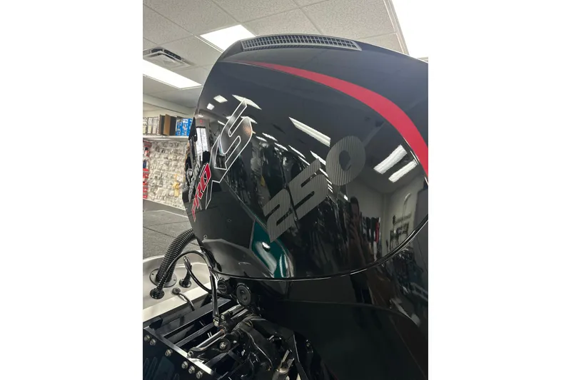 Slide: The Image of 2025 Bullet 21SDC boat engine with "250 Pro XS" branding in showroom. - 14