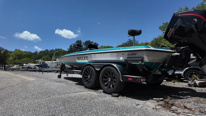 Slide: The Image of 2025 Bullet 21SDC boat on trailer, parked outdoors under clear blue sky. - 4