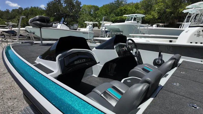 Slide: The Image of 2025 Bullet 21SDC boat with sleek design and modern interior, docked outdoors. - 7