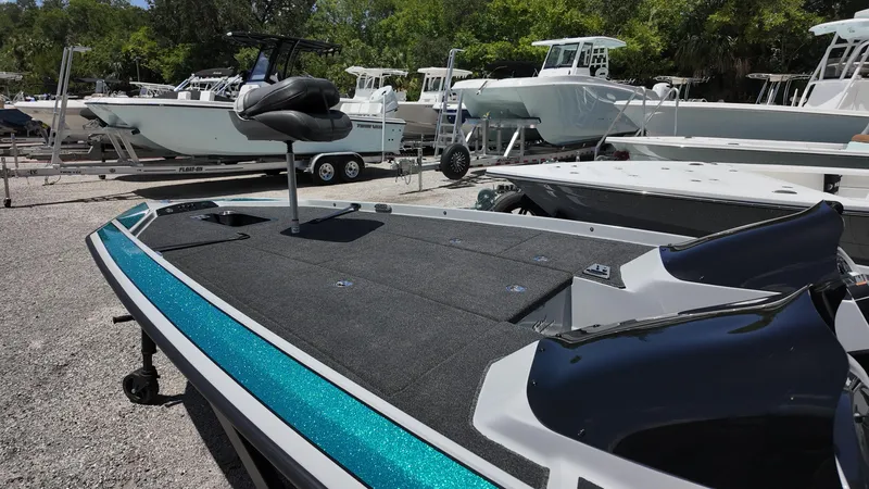 Slide: The Image of 2025 Bullet 21SDC boat with sleek design, parked among other boats. - 8