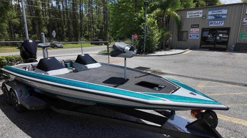 Slide: The Image of 2025 Bullet 21SDC boat on trailer outside dealership, featuring sleek design and modern features. - 9
